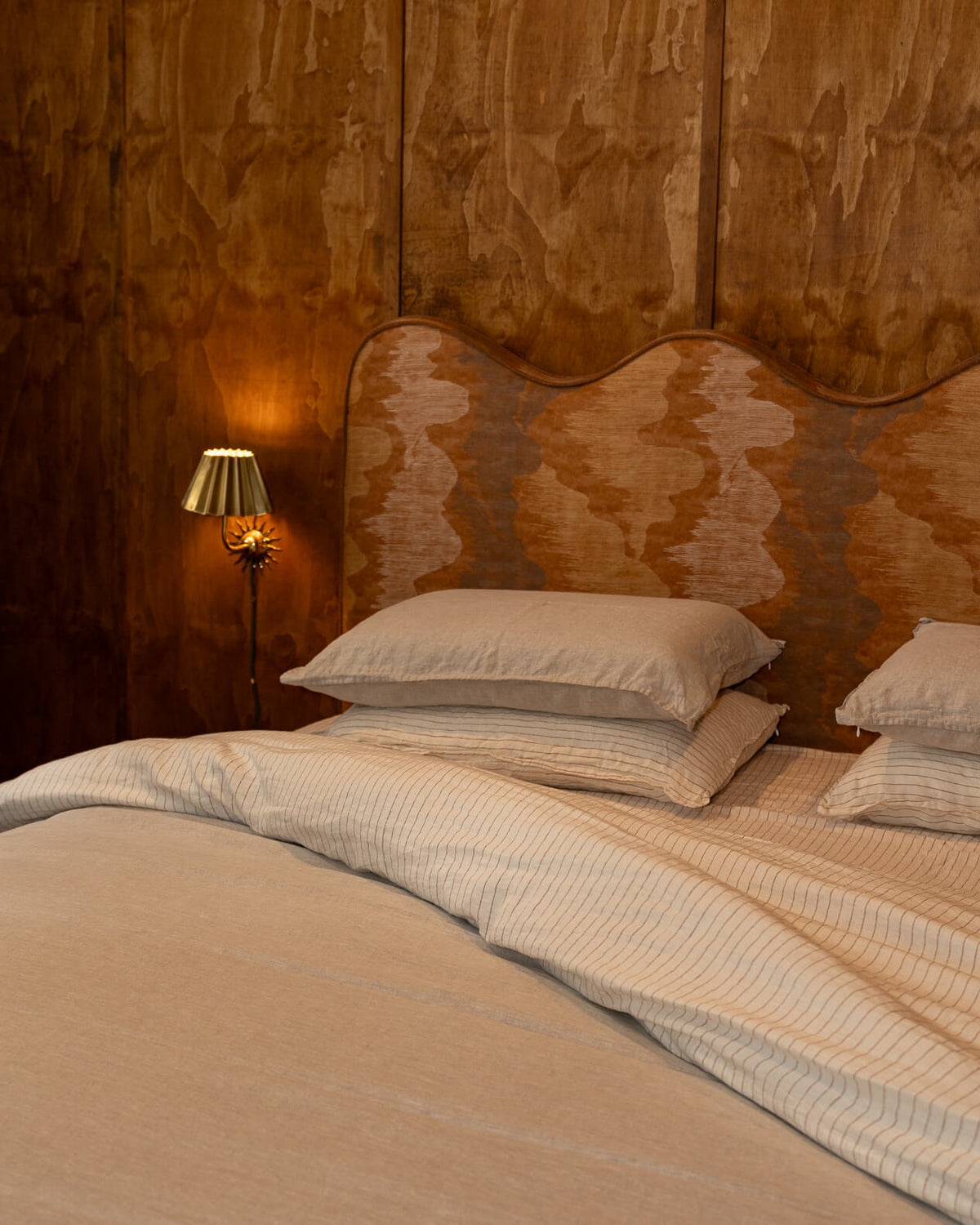 Warm tone room featuring Canyon Stripe and Dune white sheet sets.